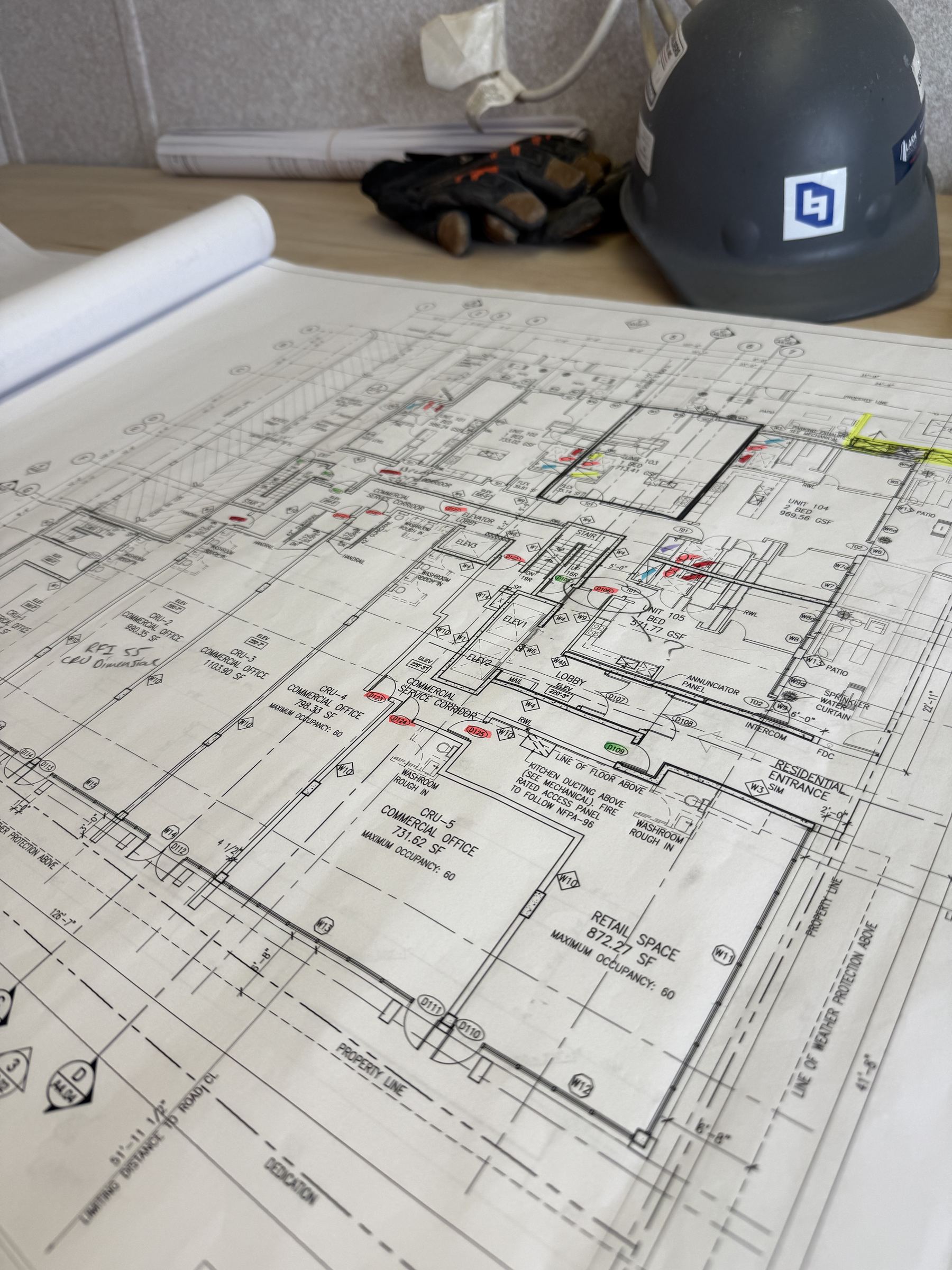 Construction drawings and hard hat on a review table
