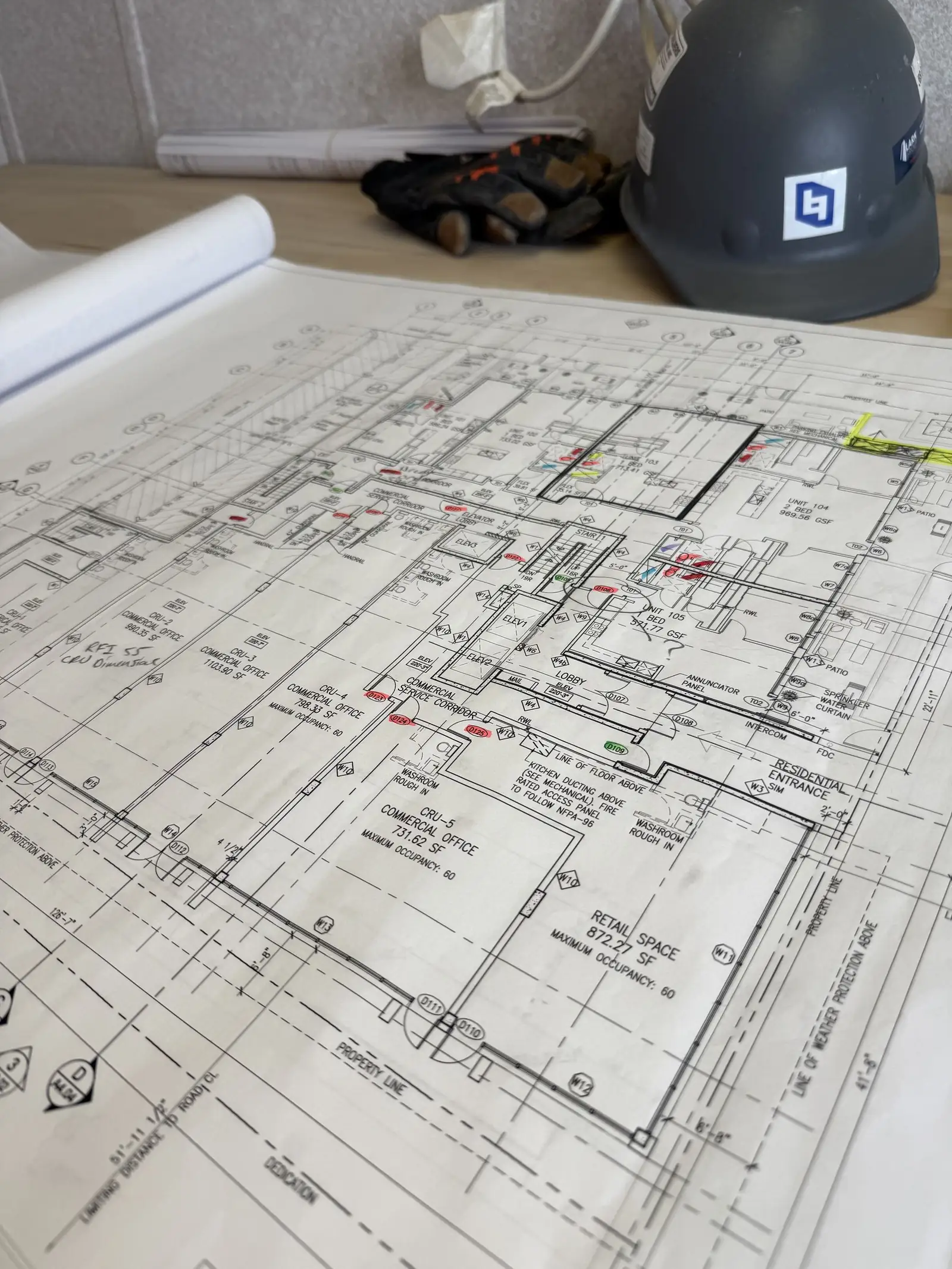Construction drawings and hard hat on a review table
