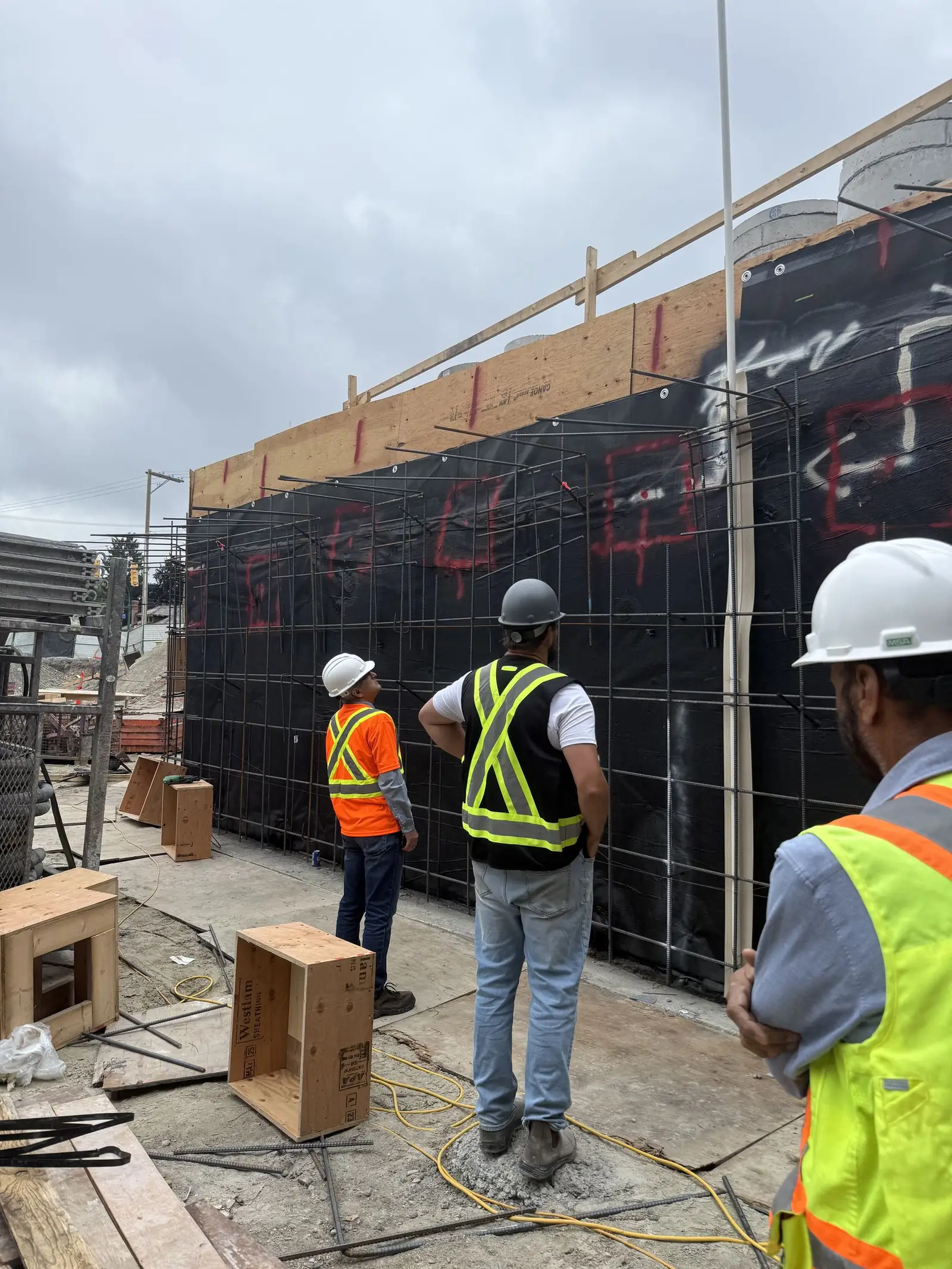 Site team reviewing structural work on an active build